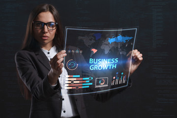 The concept of business, technology, the Internet and the network. A young entrepreneur working on a virtual screen of the future and sees the inscription: Business growth