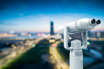 Coin operated binoculars with New York skyline in the background