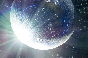 Bright patches of light on disco ball. tinted