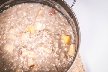 Porridge with apple in a pot - steaming hot