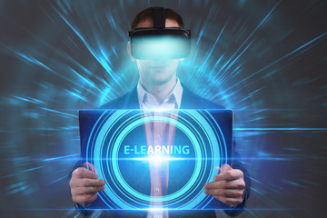 Business, Technology, Internet and network concept. Young businessman working in virtual reality glasses sees the inscription: E-learning