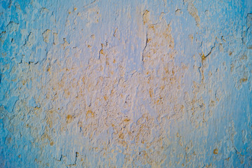 Blue and orange cracred plastering on the wall, background, texture