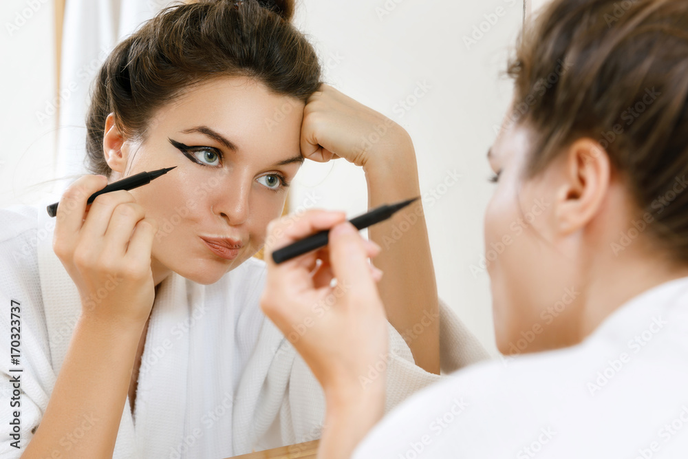 Poster Woman is disappointed with her skill of applying makeup