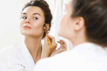 Woman applying foundation or blusher on her face