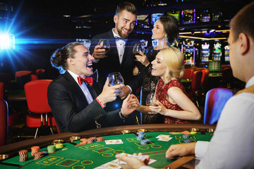 Happy people celebrating their win after successful game in the casino