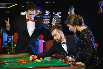 Beautiful and rich people playing roulette in the casino