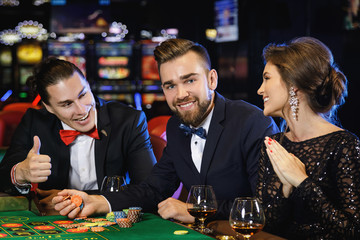 Beautiful and rich people playing roulette in the casino
