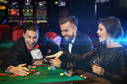 Beautiful and rich people playing roulette in the casino