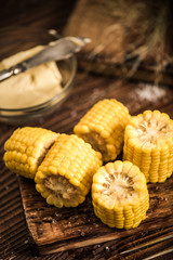 Fototapeta na wymiar Cooked and salted corn on cob with butter