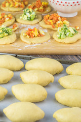 Unbaked pie bites with egg and vegetable filling.
