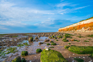 View of the beach with chalk and brownstone cliffs in Hunstanton, Norfolk UK