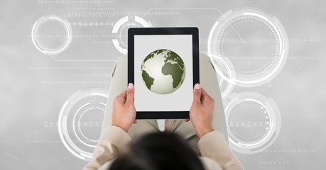 Business woman holding a tablet with a globe with connectors