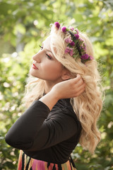 pretty young woman with wreath of flowers in hair portrait outdoor