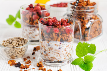 Yogurt with granola and berries in glasses