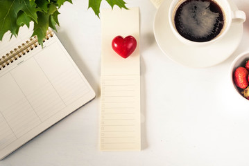 Notepad with Empty to do list, heart, coffee on the desktop