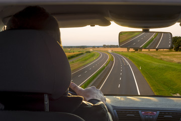 view from the inside of a car driving a busy highway, view from the driver's position