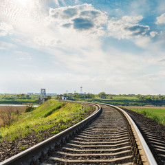 Fototapeta na wymiar railroad close-up to horizon and dramatic sky with sun