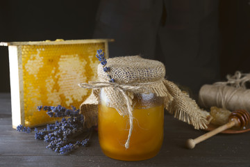 Jar of liquid honey with honeycomb