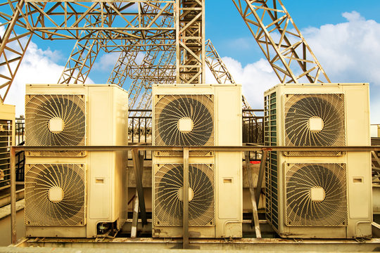 Industrial air conditioner condensers (outside unit) on the roof of a building on a hot summer day
