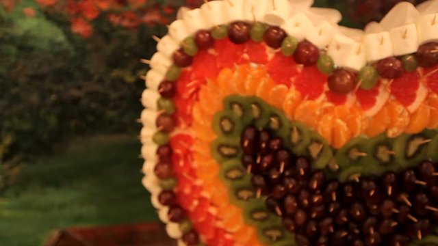 Fourchette sweet table with fruit on a background of colorful tapestry. wedding day