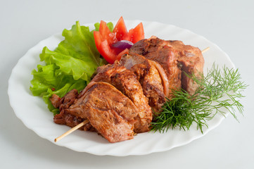 Beef pork barbecue kebab on skewer on a white plate