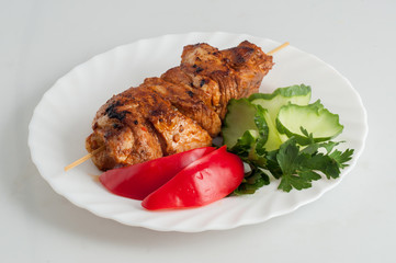 Beef pork barbecue kebab on skewer on a white plate