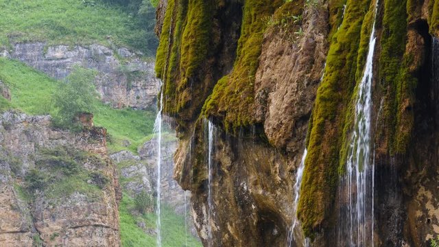 untouched nature and crystal clear water, a piece of rock overgrown with moss flowing clean water