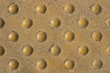 Tile in metro. Texture. With round protrusions .  Relief tactile tiles.