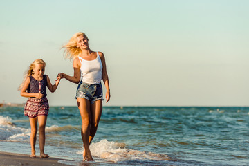 Happy family during summer vacation on against the sea, ocean