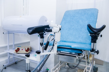 Gynecological surgery room with chair and equipment. Medical and Healthcare concept. Selective focus