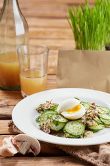 Felicious and fresh salad with cucumber, eggs and seeds.