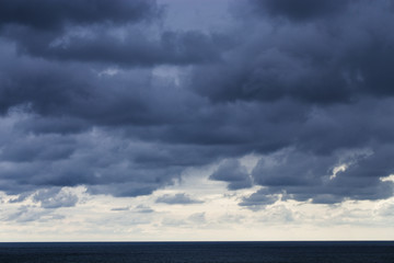 Black storm clouds over the dark sea.