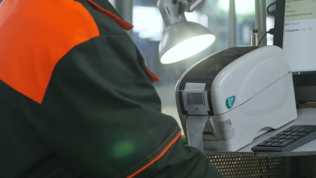 Closeup Backside View Worker Scans Barcode Printer