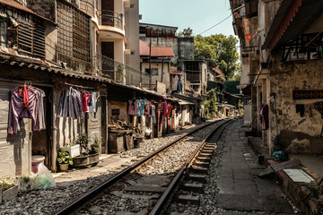 Fototapeta na wymiar Train passing through Hanoi streets and houses
