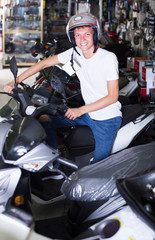 Portrait of glad  buyer in helmet on motorbike