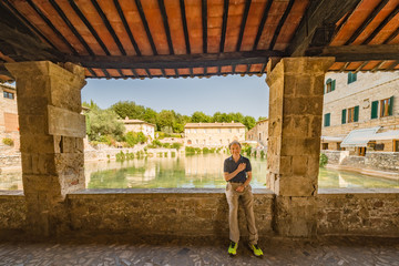 man with hand on heart on medieval public flooded square