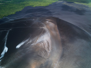 Fototapeta premium People walk on volcano ash