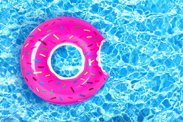 Inflatable colorful donut in swimming pool
