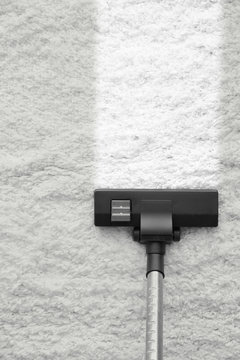 Vacuum cleaner removing dirt from carpet