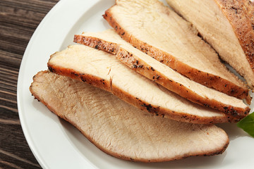 Delicious sliced turkey on white plate, closeup
