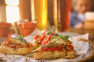 Delicious molletes with fillet of fish and vegetables on plate