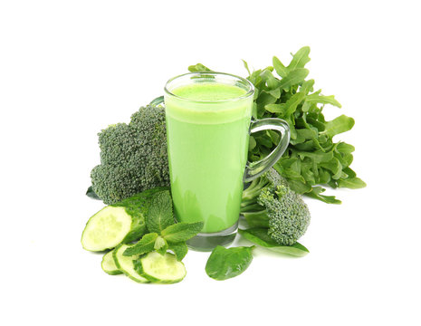 Glass of green healthy juice with vegetables on white background