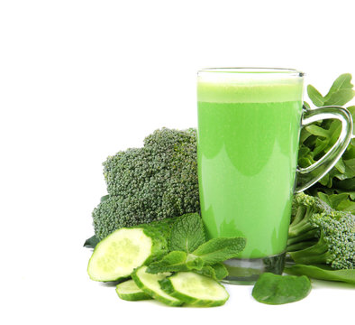 Glass of green healthy juice with vegetables on white background