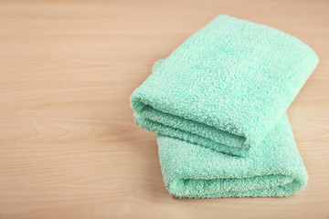 Clean towels on wooden table