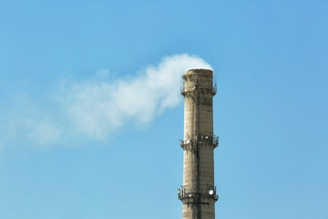 Flue of industrial factory on sky background