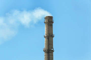 Flue of industrial factory on sky background