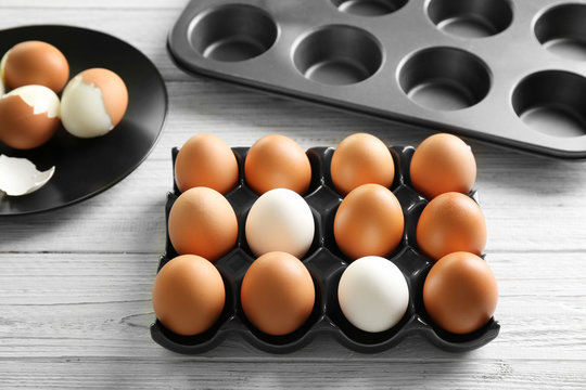 Holder with hard boiled eggs on wooden table