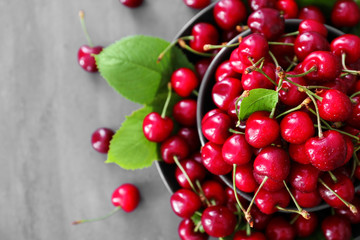 Fresh ripe cherries on grey background