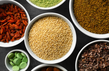 Composition with assortment of superfood products in bowls, closeup