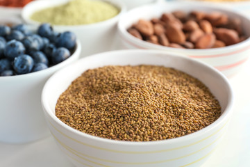 Composition with assortment of superfood products in bowls on white background, closeup